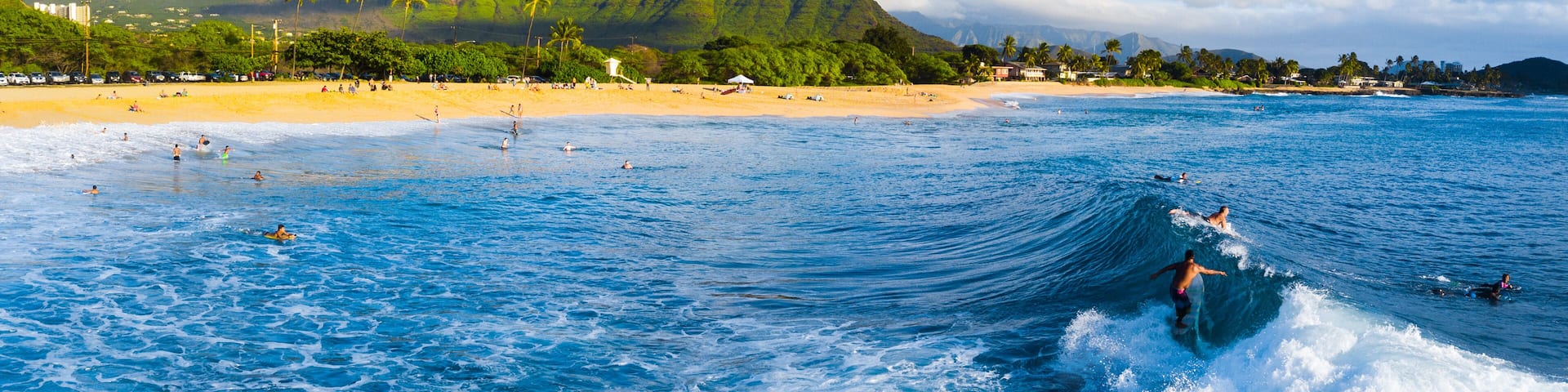 Panorama of the surf spot Makaha with the surfer riding the wave. Oahu, Hawaii