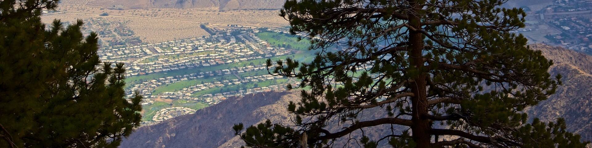 A mountainous landscape with a town in the valley below.
