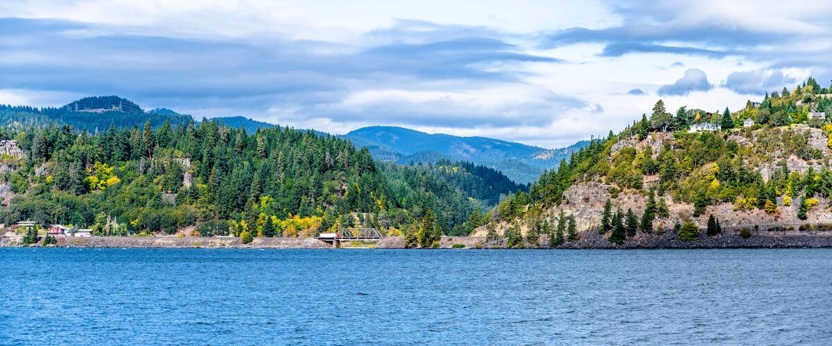 Columbia River Bank with Hills Overgrown with Trees and Hilltop Residences in the Hood River