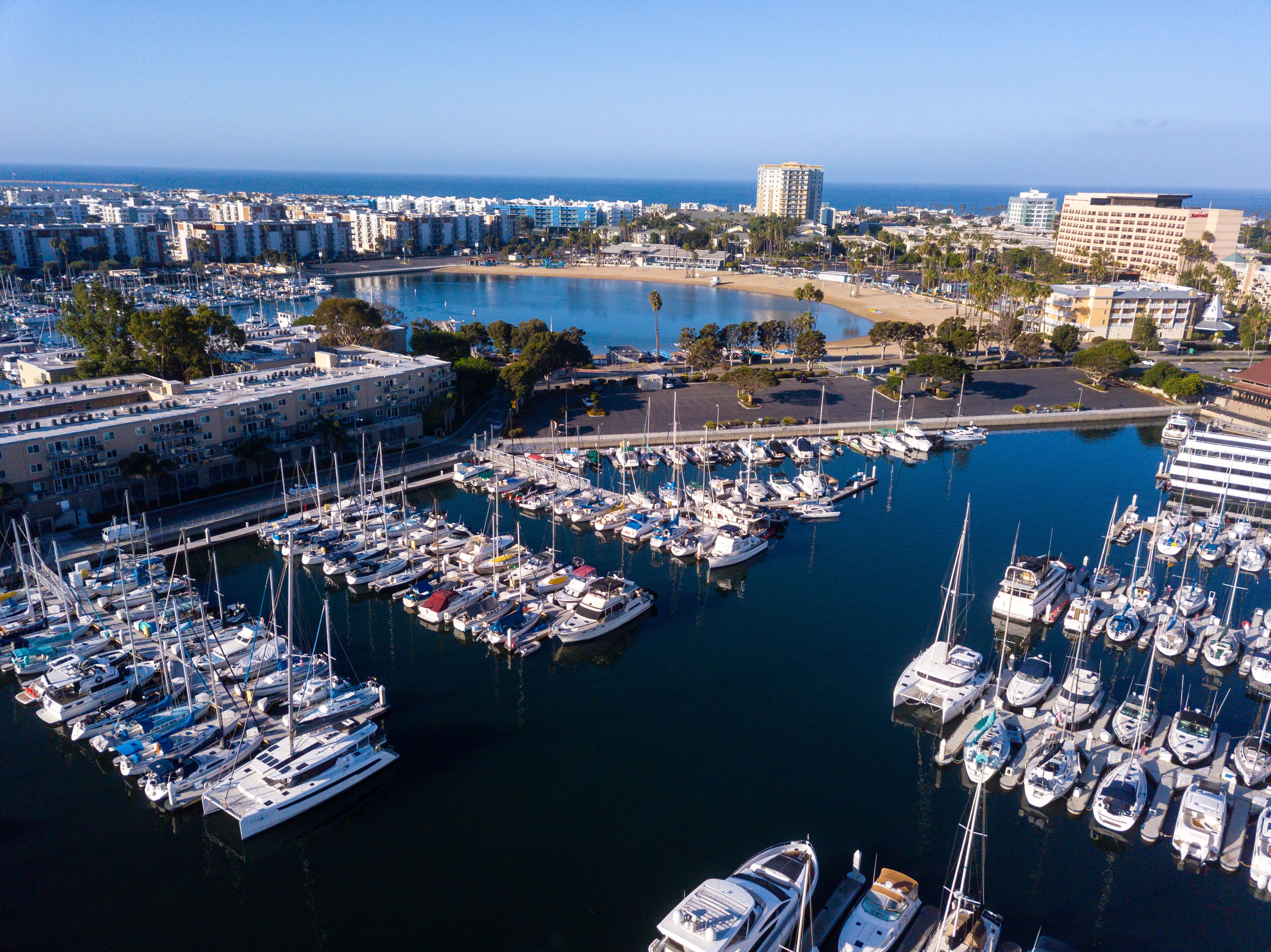 Aerial drone views of the marina in Marina Del Rey, California in the morning light. Views of docked boats, marina beach, marina towers, venice and marina del Rey neighborhoods, the beach, and Los Ang
