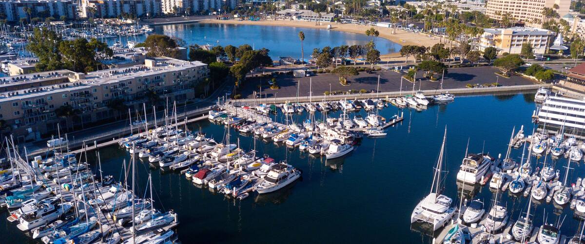 Aerial drone views of the marina in Marina Del Rey, California in the morning light. Views of docked boats, marina beach, marina towers, venice and marina del Rey neighborhoods, the beach, and Los Ang