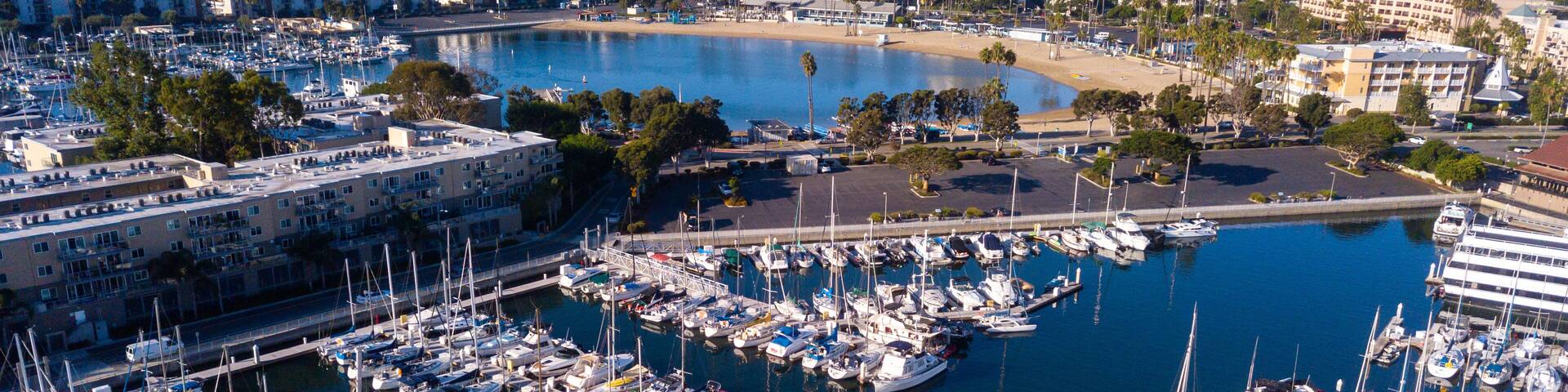 Aerial drone views of the marina in Marina Del Rey, California in the morning light. Views of docked boats, marina beach, marina towers, venice and marina del Rey neighborhoods, the beach, and Los Ang