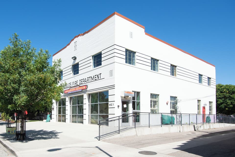 A white building with a red roof and the sign "Children's Museum".