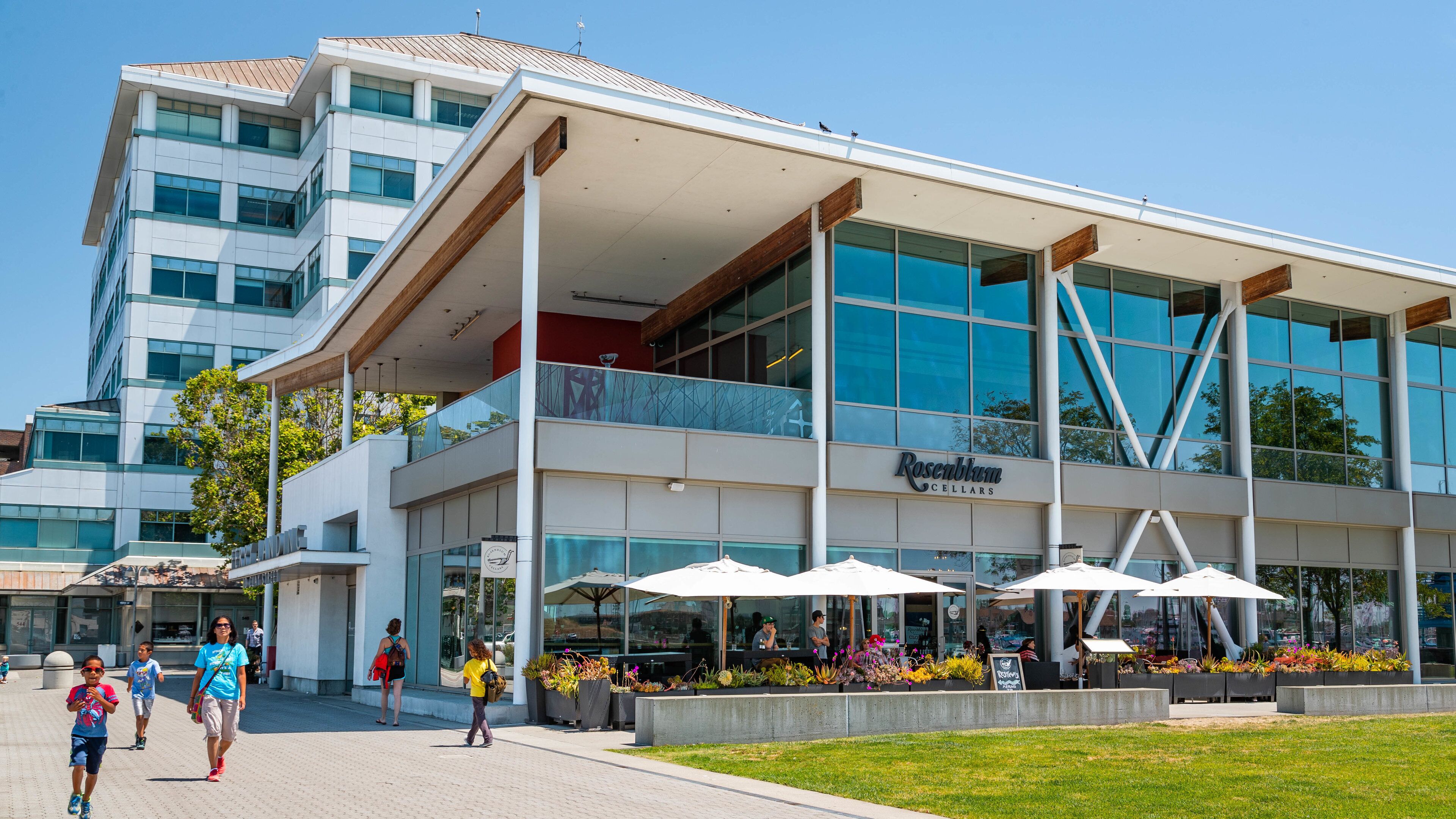 A modern building with a glass facade and a sign reading "Rosebloom Cellars".