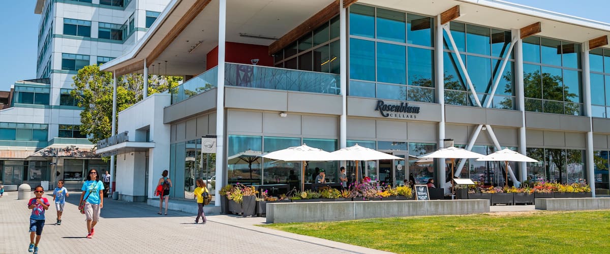 A modern building with a glass facade and a sign reading "Rosebloom Cellars".