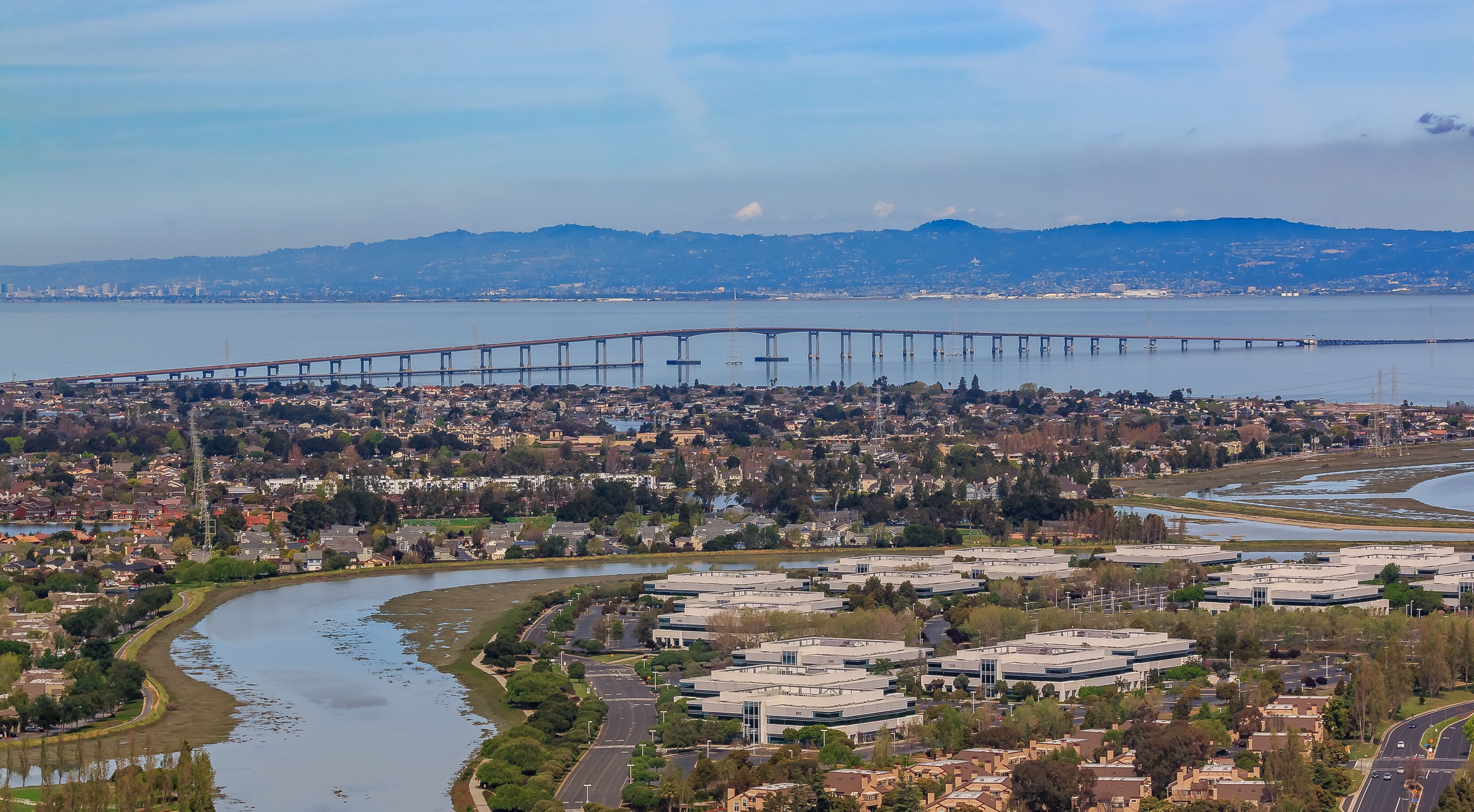 Aerial view from an airplane of San Mateo Hayward bridge across the San Francisco Bay and Foster City in  San Mateo County, California