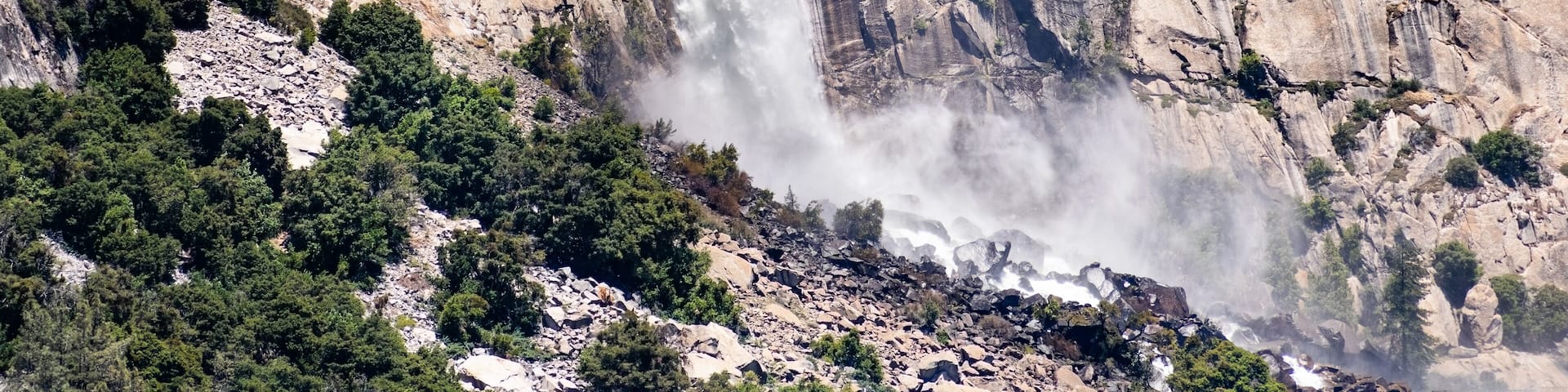View towards Wapama falls dropping along granite walls; Hetch Hetchy Reservoir area, Yosemite National Park, Sierra Nevada mountains, California