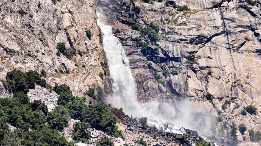 View towards Wapama falls dropping along granite walls; Hetch Hetchy Reservoir area, Yosemite National Park, Sierra Nevada mountains, California