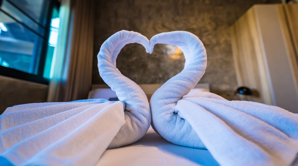 Swans made of towels at the hotel.Love concept honeymoon bed for home or hotel bedroom decoration.