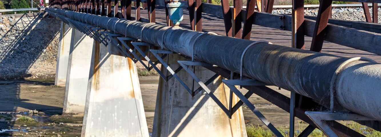 Distinctive wooden trestle footbridge used by bicyclists, runners and dog walkers to cross over the Santa Ana River. Huntington Beach, CA.