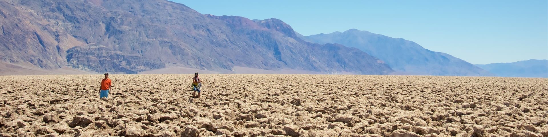 Devil\'s Golf Course featuring desert views and landscape views as well as a small group of people