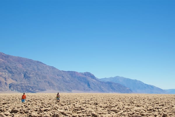 Devil\'s Golf Course which includes desert views and landscape views as well as a small group of people