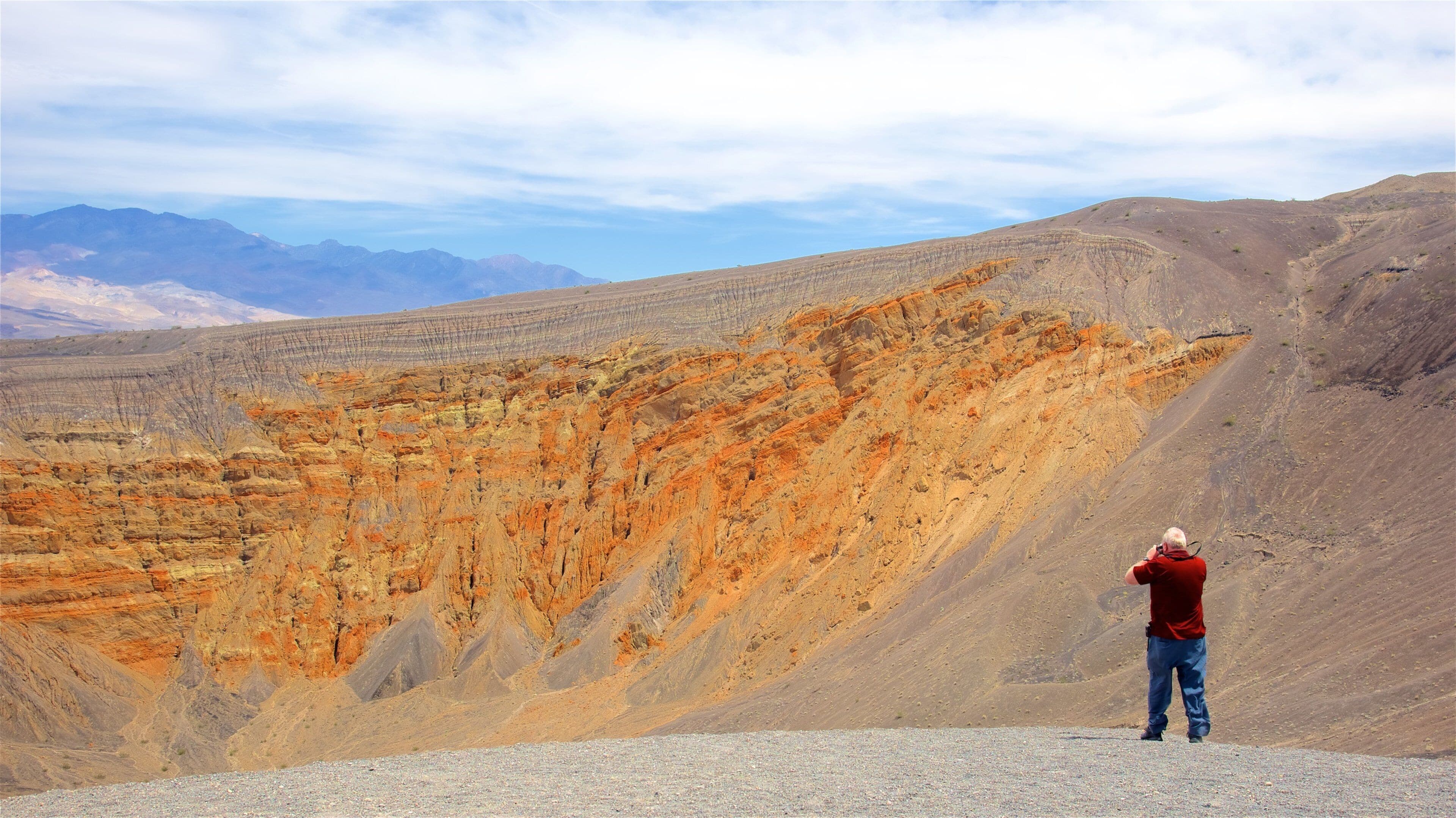 Ubehebe Crater featuring desert views and landscape views as well as an individual male