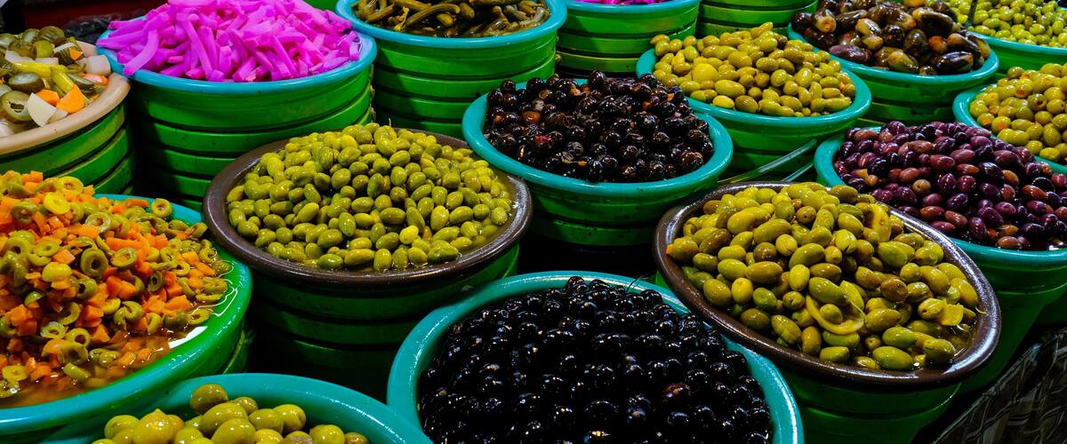 Selection of assorted olives, featuring a colorful array of green, black, and purple varieties