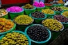 Selection of assorted olives, featuring a colorful array of green, black, and purple varieties