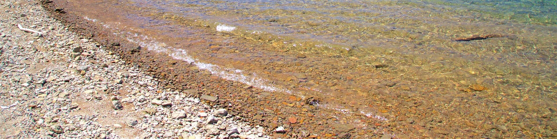 Juniper Lake featuring a pebble beach, tranquil scenes and a lake or waterhole