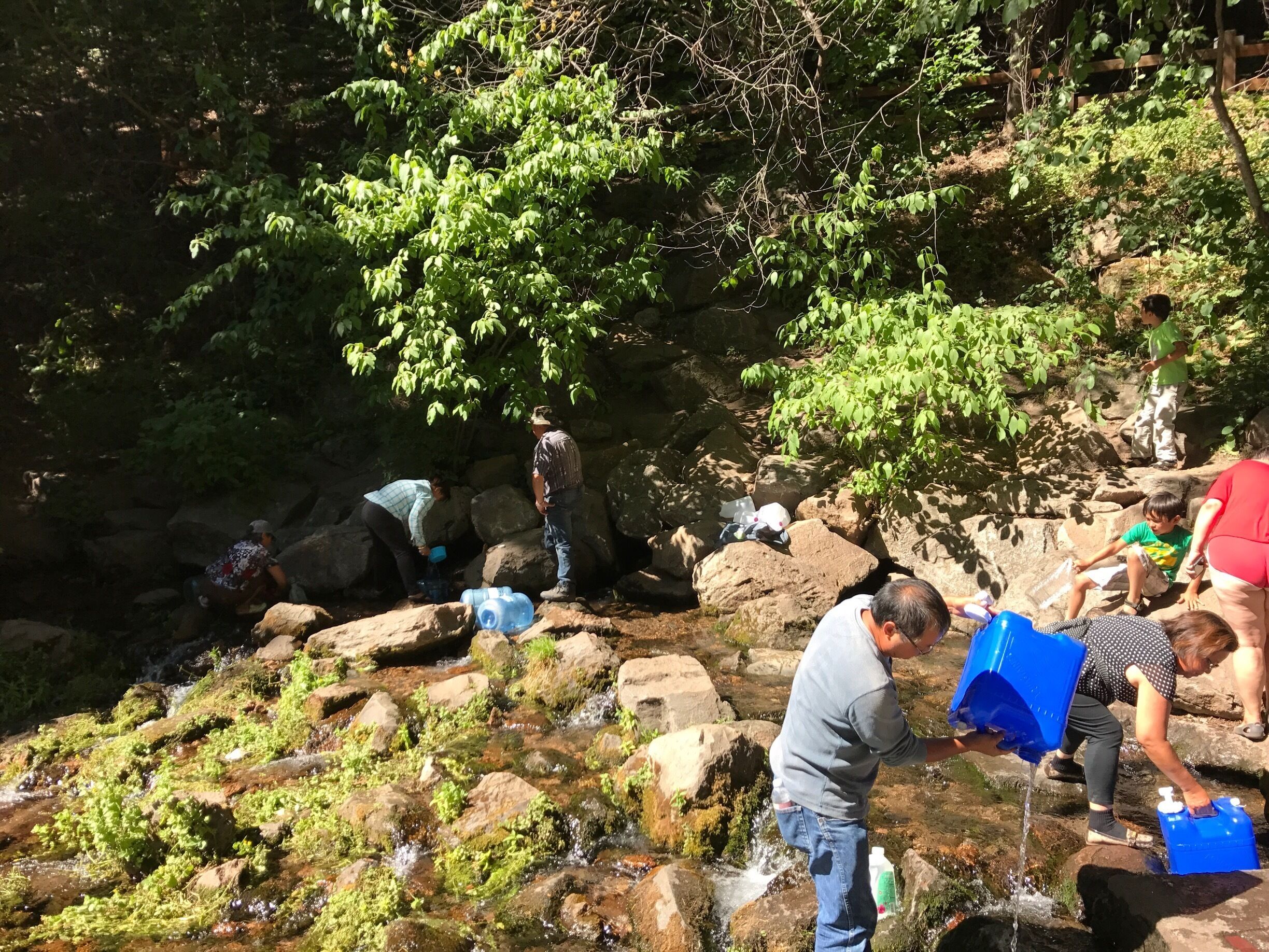 Just inside the park people filling up jugs of this world famous glacier melt water 