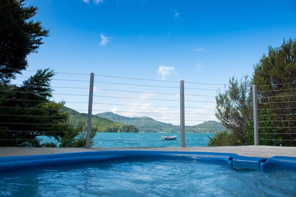 A swimming pool with a view of a lake and mountains.