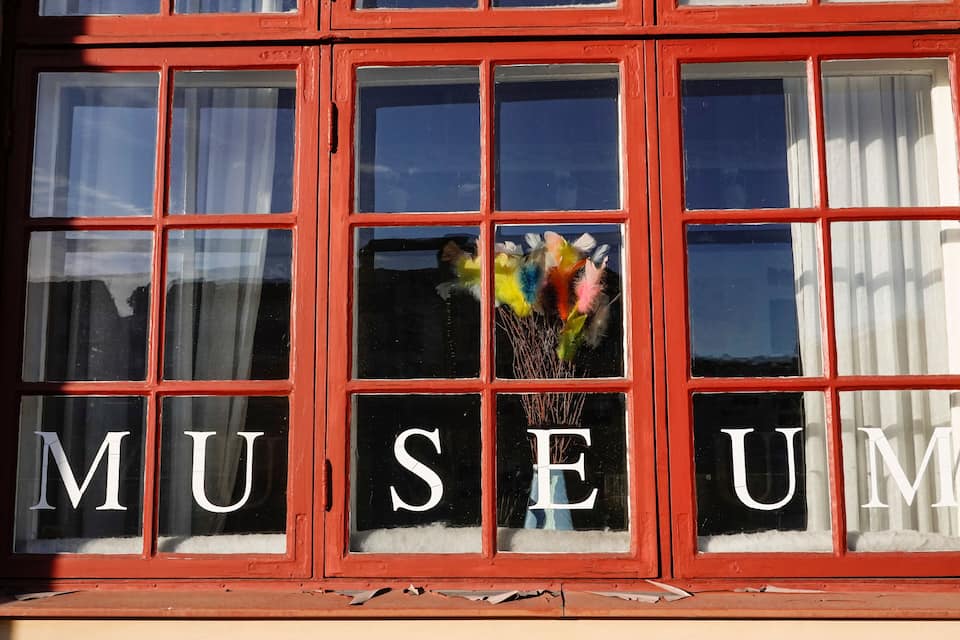 A window with the word "MUSEUM" spelled out in large letters.