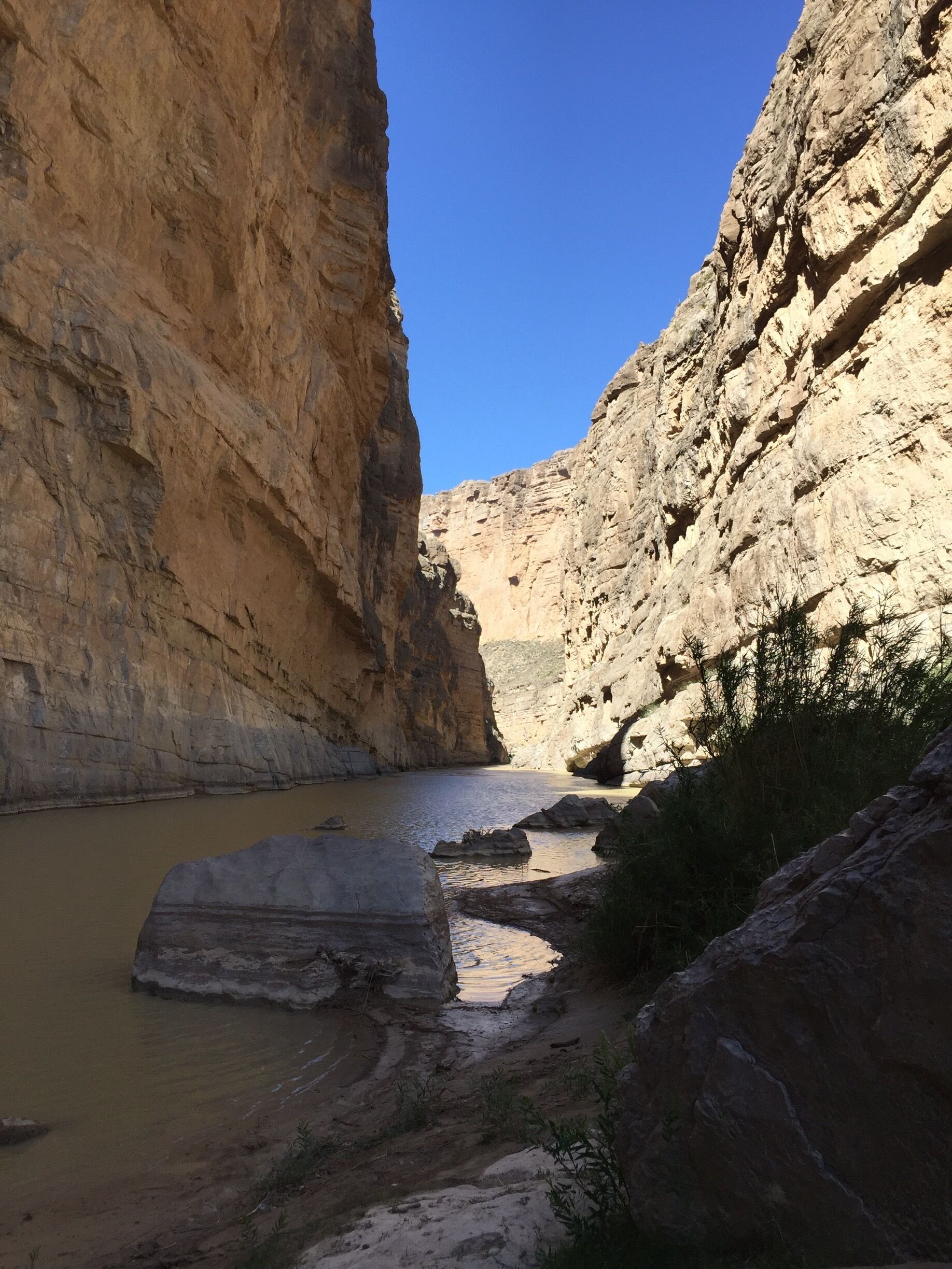 Depending on the water level, you might need to wade thru or step over a relatively narrow creek to get to the best viewing spot overlooking Santa Elena Canyon in Big Bend National Park. In the picture, the left side of the river is Mexico; USA is on the right side.