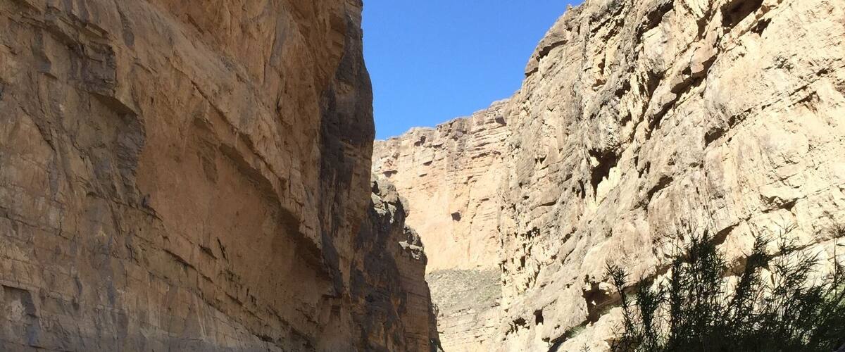 A canyon with a river flowing through it.