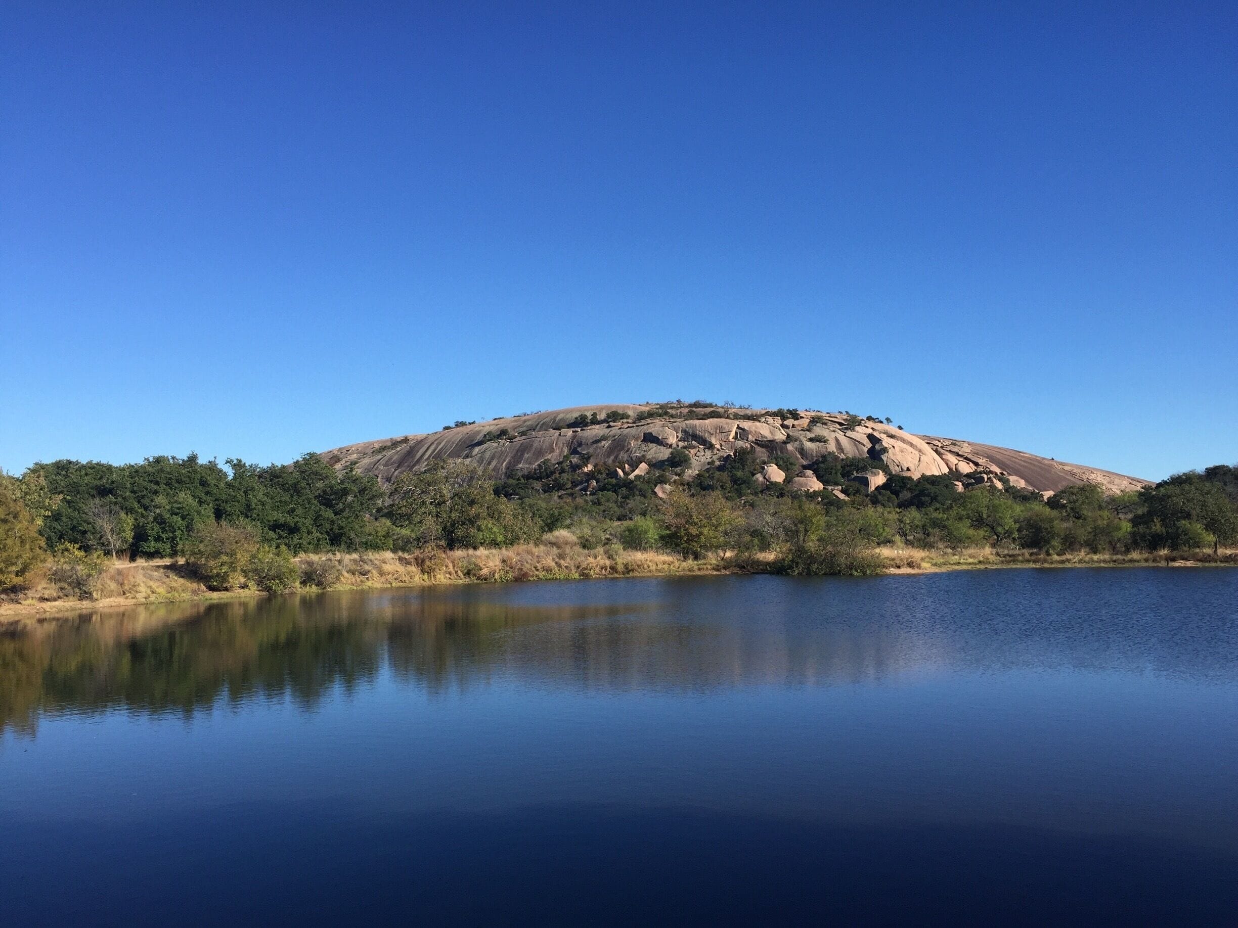 View of the west side of Enchanted Rock across Moss Lake. This state natural area offers spectacular hiking opportunities. 