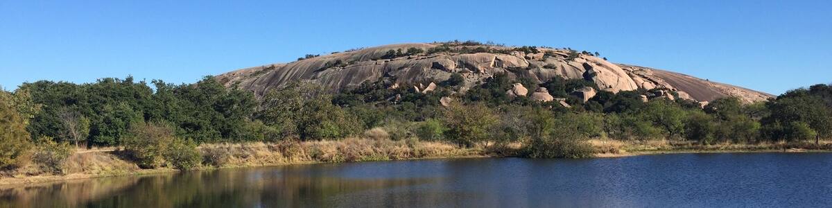 View of the west side of Enchanted Rock across Moss Lake. This state natural area offers spectacular hiking opportunities.
