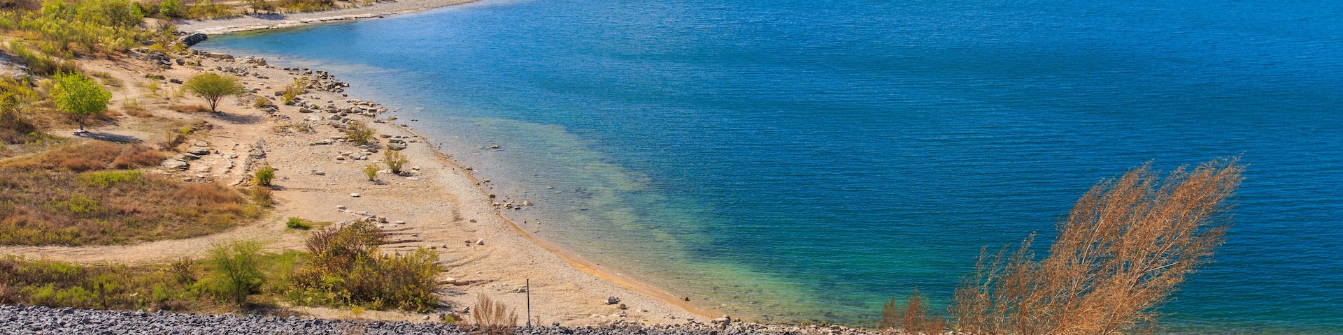 Canyon Lake close to San Antonio, New Braunfels, San Marcos and Wimberley in the Texas hill country. It is part of the Guadalupe River. You can walk on the dam. There are many beaches on the shores.