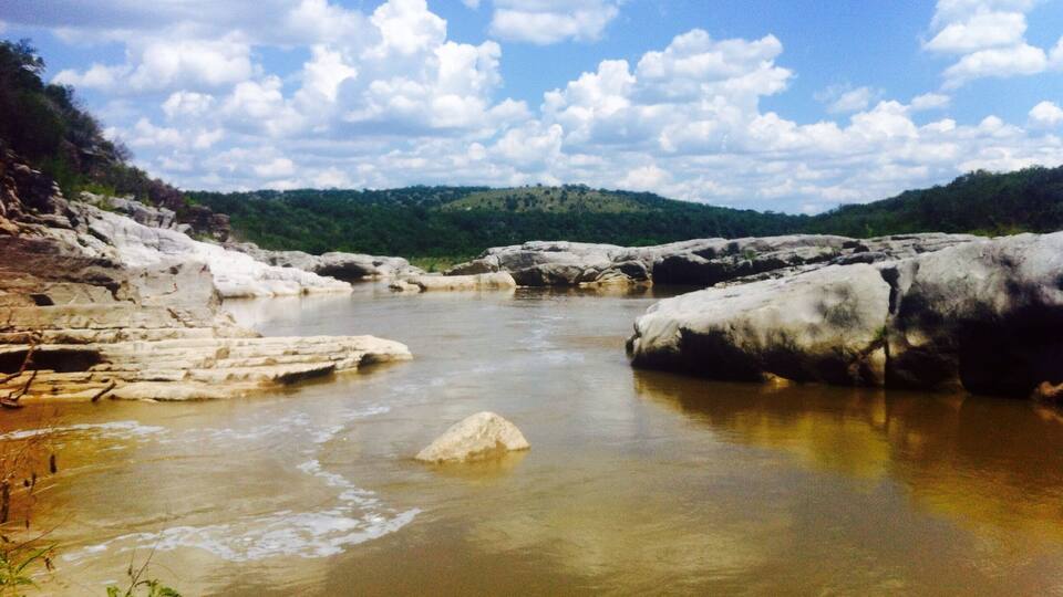 A river with rocky banks and a clear sky.