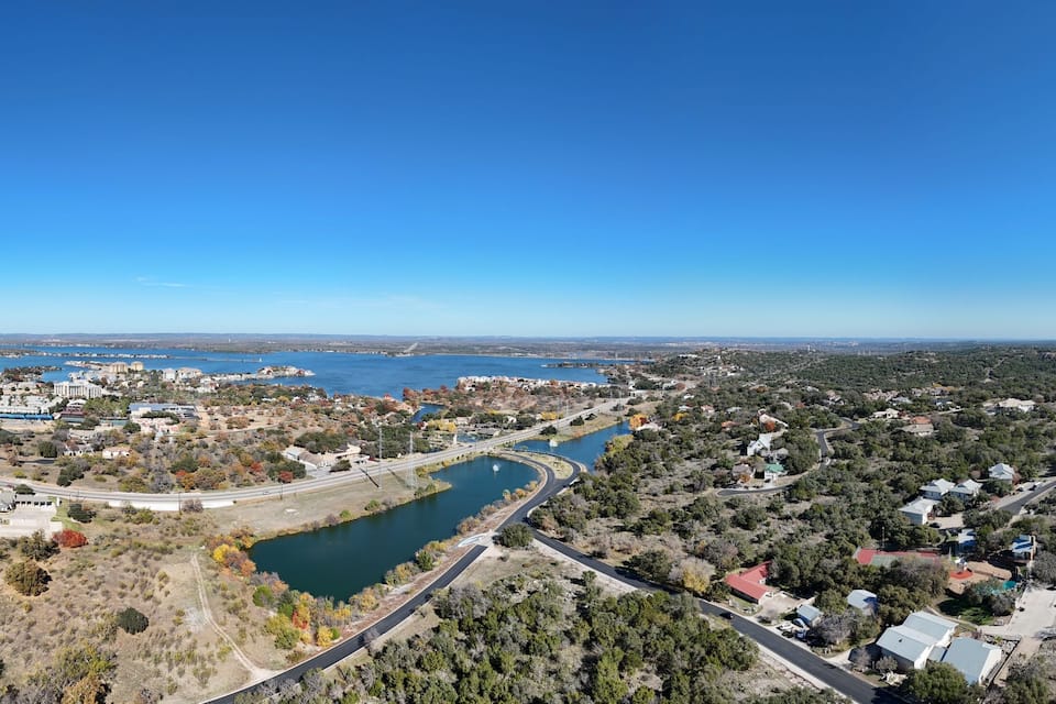 A coastal town with a river, a bridge, and a mix of residential and commercial buildings.