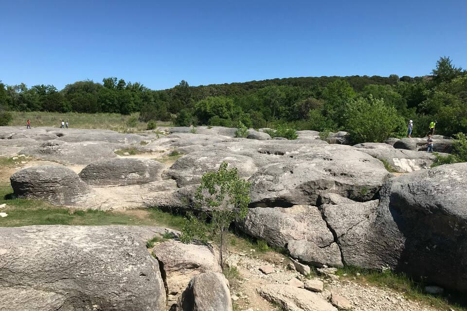 Large boulders with visible cracks and a clear sky.