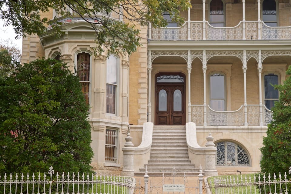 Un edifici històric amb balcons ornamentals, una entrada imponent i un senyal que indica propietat privada.