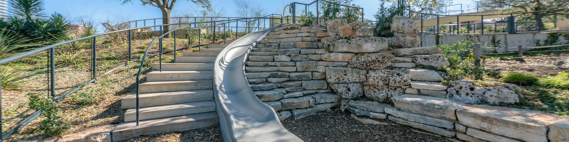 Stairs and slide amid scenic nature views at Waterloo Park in Austin Texas