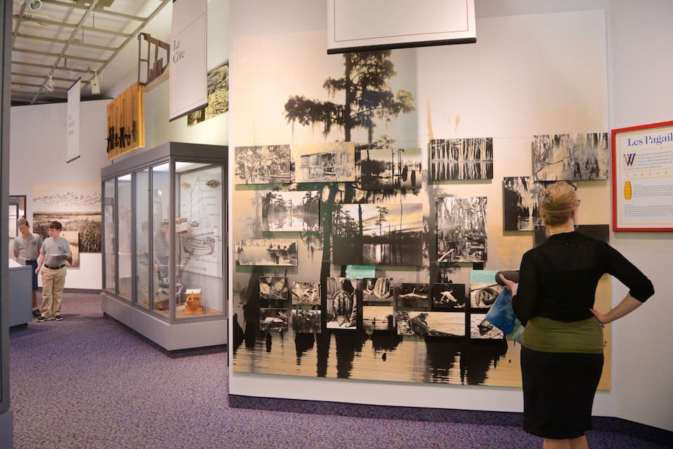 An indoor exhibition with historical photographs and documents.