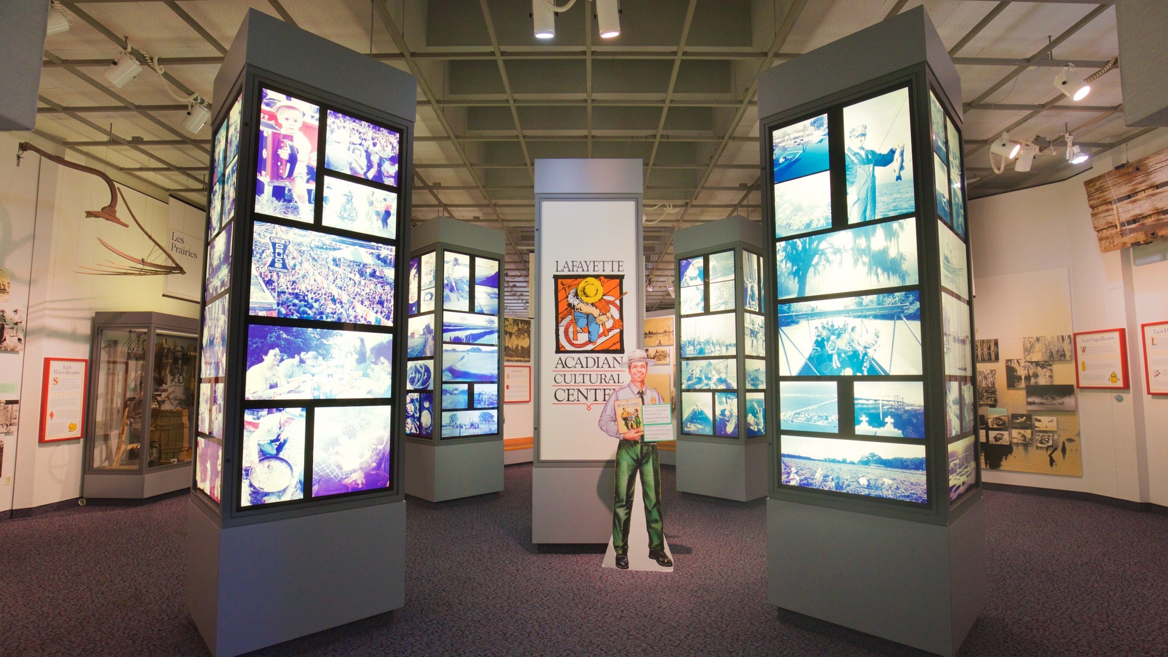 A museum exhibit with large display panels and a central poster.