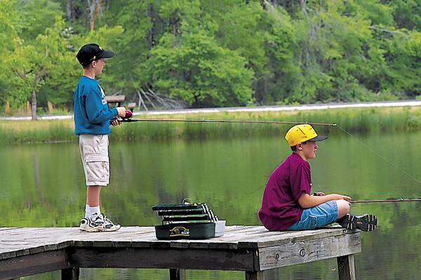 Camden featuring fishing and a lake or waterhole as well as children