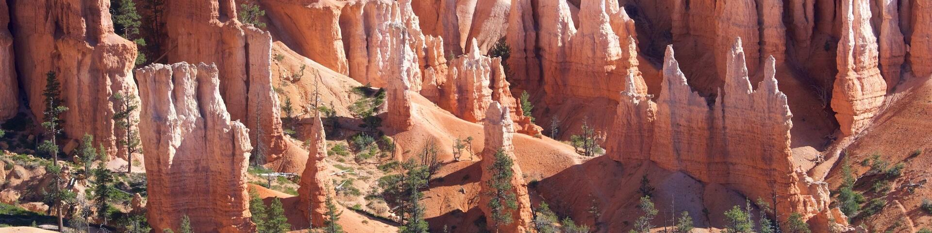 A landscape of red rock formations with spires and pinnacles.