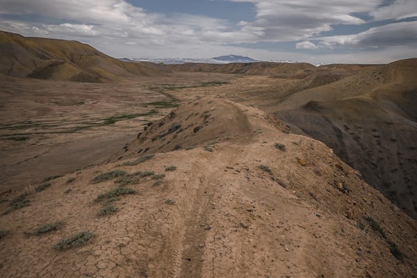 Narrow Trail on top of adobe clay ridgeline on hill in Peach Valley badlands in off road recreation area near Montrose Colorado