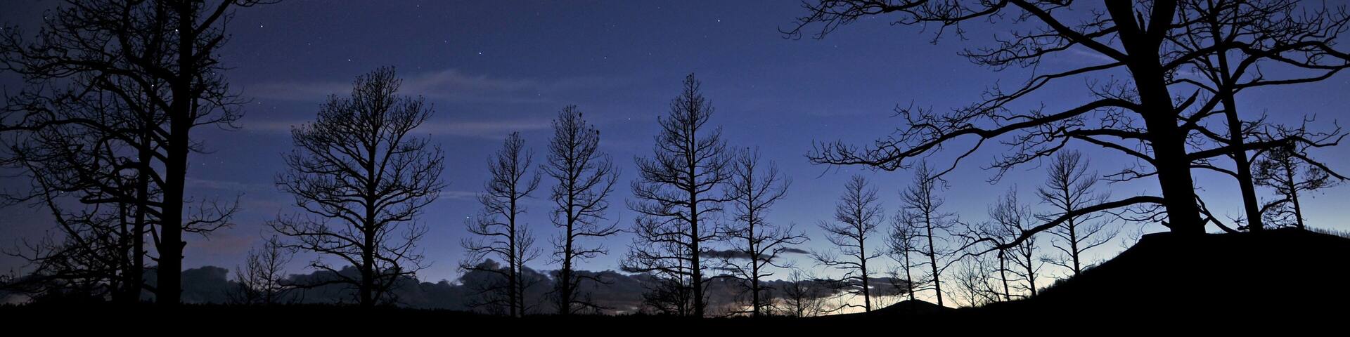 A tent illuminates the starry night sky at Sugarite Canyon State Park near Raton Pass on the New Mexico and Colorado borders.