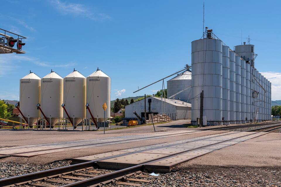 A railway track with grain silos and a grain elevator.