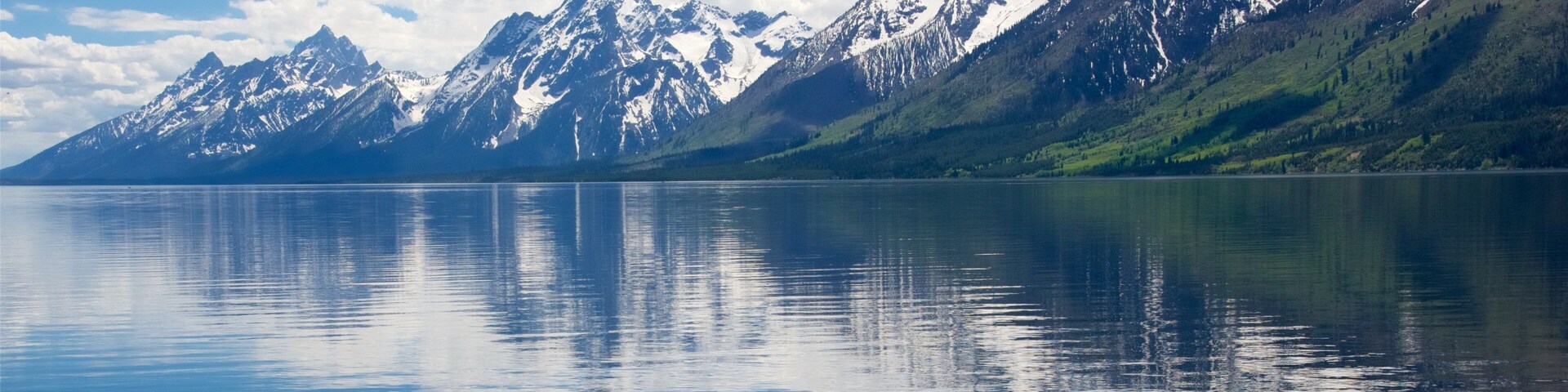 Jackson Lake que incluye un lago o espejo de agua y montañas