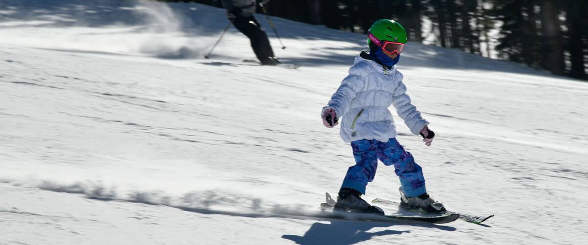 Kid snowboarding on snowy hill. Extreme winter sports. Action shot. Vail ski resort, Colorado