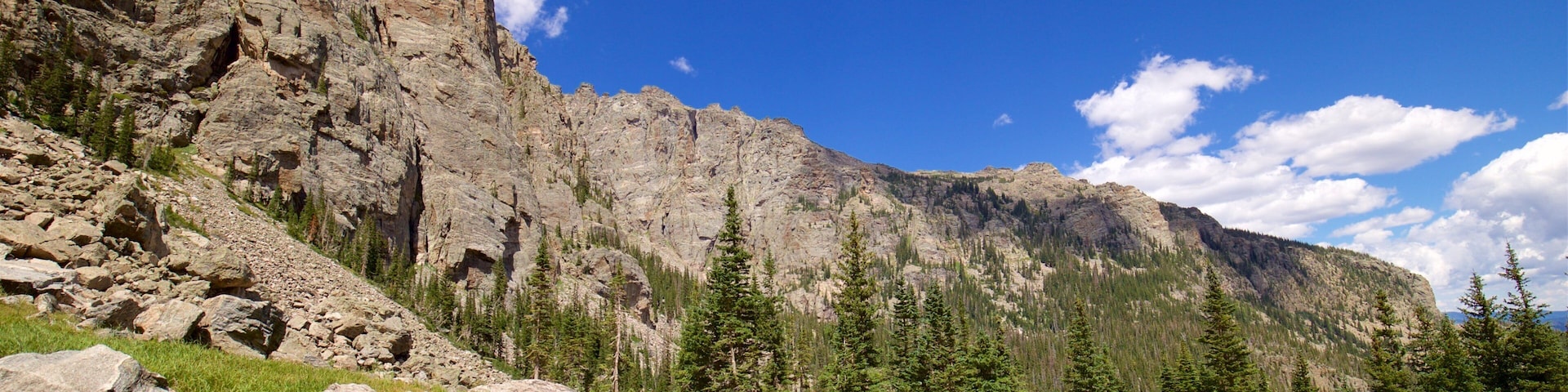 Sky Pond featuring tranquil scenes and hiking or walking as well as a small group of people