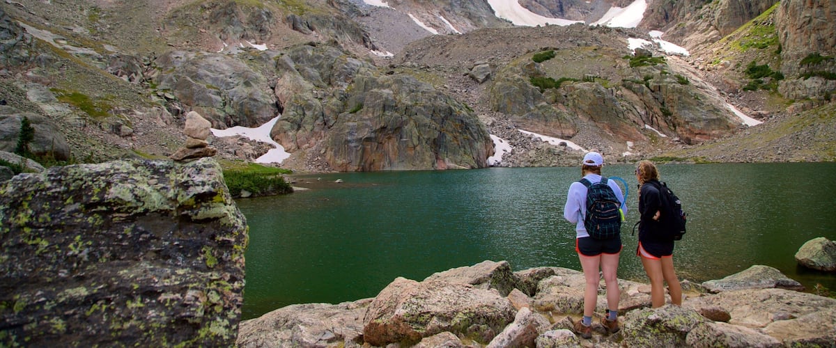 Sky Pond showing a lake or waterhole and hiking or walking as well as a couple