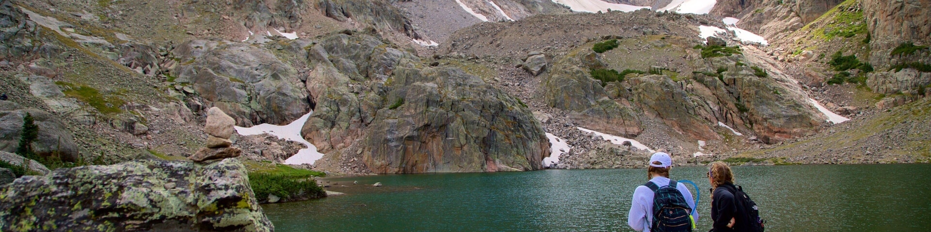 Sky Pond showing a lake or waterhole and hiking or walking as well as a couple