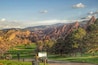 A golf course with a mountainous backdrop.