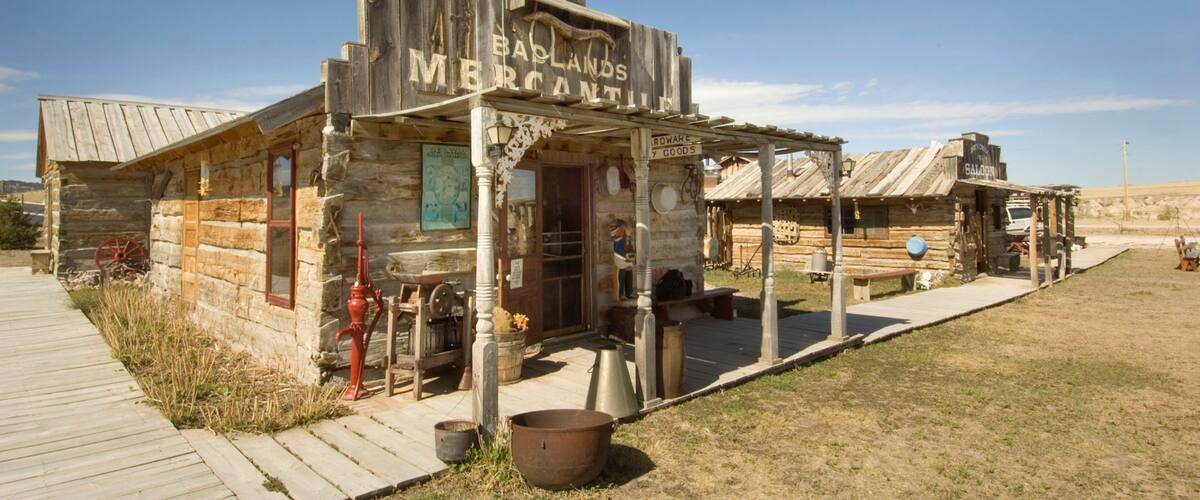 A rustic wooden building labeled "Badlands MFRANTIN" with a sign for "Hardware & Goods" and a saloon named "Galoony."