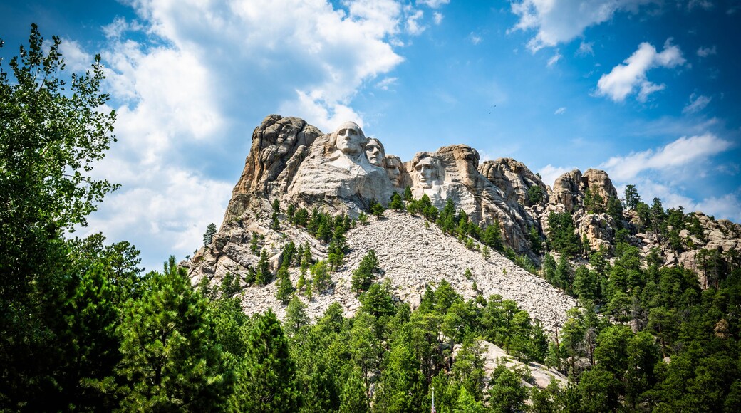 Mount Rushmore National Monument memorial in South Dakota with blue sky and cumulus clouds