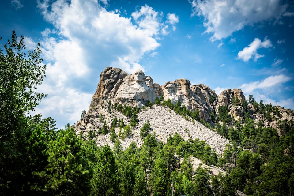 A mountain with rocky peaks and a clear blue sky.
