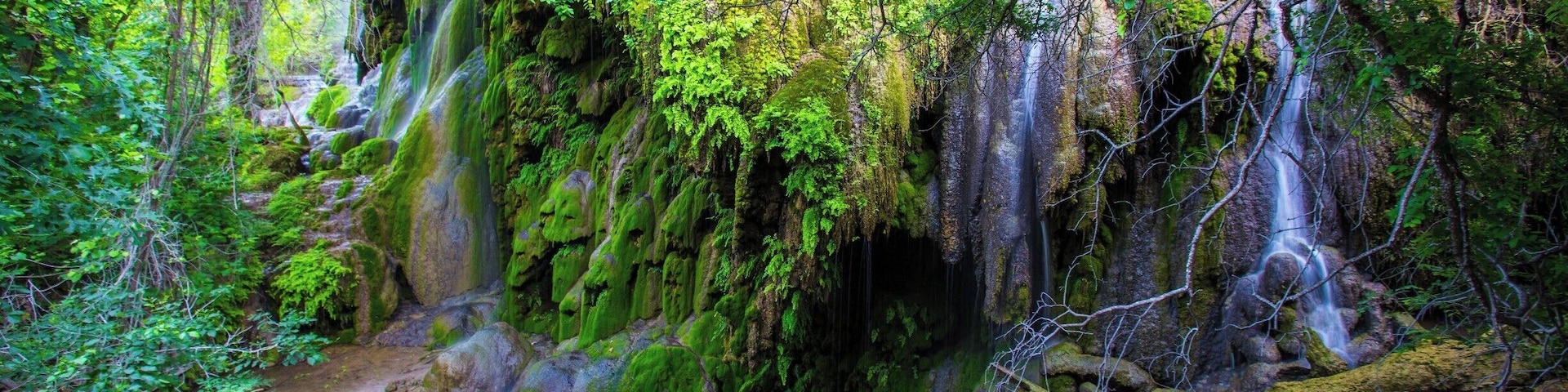 As a longtime Texas resident, Gorman Falls is one of my favorite places.  It is a waterfall in Colorado Bend State Park that is a wonderful reprieve from the typically hot summer days. The falls are spring fed and covered with travertine (cave formations) that have formed over the millennia.  The falls essentially create a cool otherworldly microclimate.  While the park offeres ample camping, the nearby town of Llano can be enjoyed by those who prefer a hotel room and a bed. Be sure to enjoy a stop at the nearby Fiesta winery if in the area.  The wine isn't anything special, but it's drinkable and the owners are often there and will share with you the history of their land and operation.